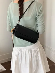 Chic black shoulder bag for women, stylish faux leather crossbody baguette bag everyday wear.