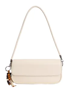 Minimalist cream shoulder bag for women, stylish underarm bag with beaded charm for daily commuting.