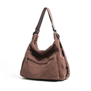 Bolso bandolera de lona marrón con bolsillos con cremallera, diseño casual para uso diario.