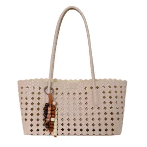 Beige hollow woven tote bag for women, stylish large capacity commuter shoulder handbag.
