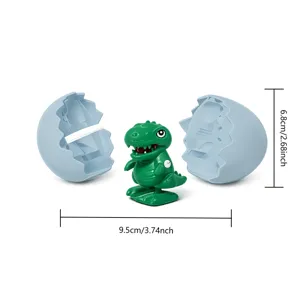 Divertido juguete de dinosaurio verde de cuerda con cáscara de huevo azul para niños.