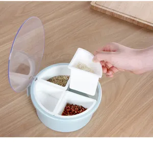 Detail view of a round 4-grid seasoning box with clear lid, showing removable container.