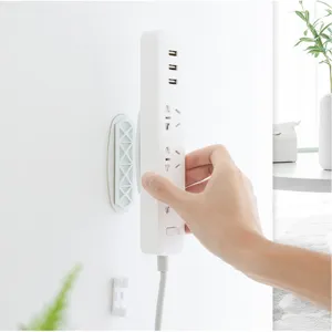 Self-adhesive power strip holder wall mount punch-free socket fixer for home office.