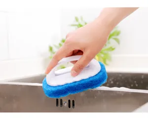 Detail view of cleaning sponge with white handle scrubbing stainless steel kitchen sink.