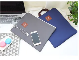 Detailaufnahme von Canvas Laptoptasche und Aktenordner mit Griff und Fächern.