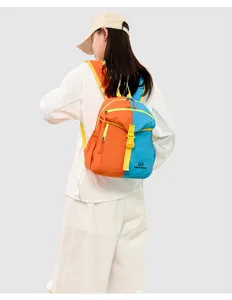 Detailed back view of a colorful children outdoor backpack in orange and blue with straps.