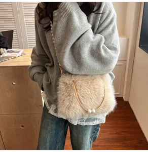 Plush fuzzy shoulder bag for women, stylish crossbody handbag with pearl chain detail.