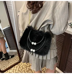 Black plush handbag with pearl handle and chain strap for women, stylish faux fur shoulder bag.