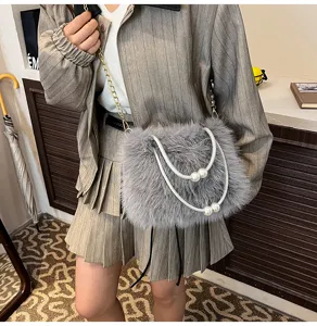 Grey plush faux fur shoulder bag with elegant pearl double handles and chain strap detail.