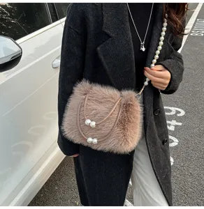 Close-up detail of fluffy plush crossbody bag with pearl chain handle and elegant winter design.