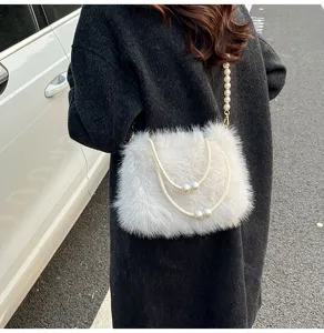 Detailed view of fluffy plush handbag with pearl handles and chain strap for women.