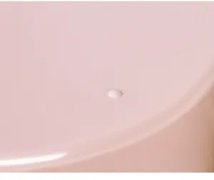 Pink seasoning box detail shot with a white knob, minimalist kitchen storage container.