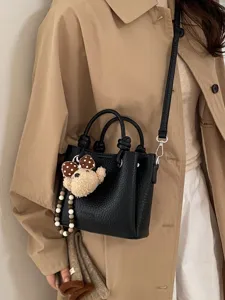 Women black leather tote shoulder bag with cute bear charm for casual daily wear