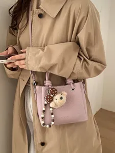 Trendy women bucket bag chic casual shoulder crossbody handbag with cute bear charm for daily use.