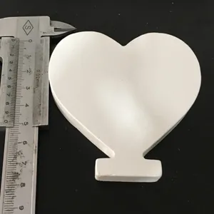 White heart wooden ornament detail view displaying exact dimensions with measuring caliper.