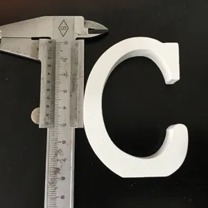 Detailed view of white wooden letter C, perfect for home wedding decor and photography props.