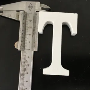 White wooden letter T ornament detail shot, minimalist decor prop for home and wedding display.