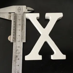 White wooden letter X ornament, wedding and home decor detail shot showing actual size with caliper.