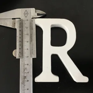 White wooden letter R ornament detail shot, perfect for home decor and wedding displays.