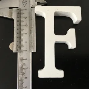 White wooden letter F decor detail view, shown with caliper measuring size for home display.