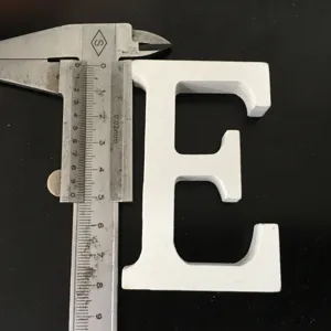 Closeup white wooden letter E ornament, ideal for home decor, wedding props and shooting photos.
