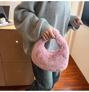 Detailed shot of a soft pink plush handbag showcasing its fluffy texture in a cozy indoor setup.