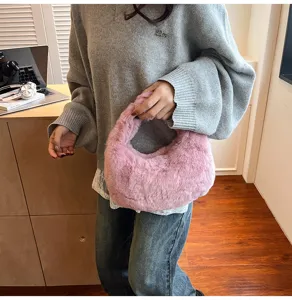 Detailed view of a soft pink plush hobo bag, showcasing the fluffy texture and chic design.