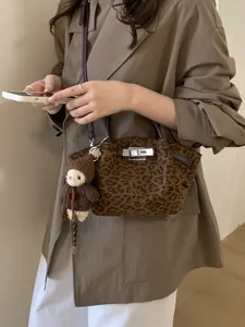 Retro leopard print handbag with knit bear pendant, stylish shoulder crossbody bag.