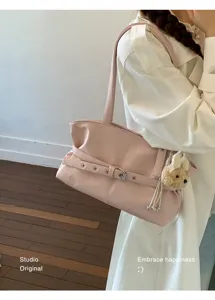 Pink casual PU leather shoulder bag for women with chic buckle and cute charm detail.