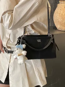 Minimalist Korean women shoulder crossbody bag with cute bear pendant for daily commute.