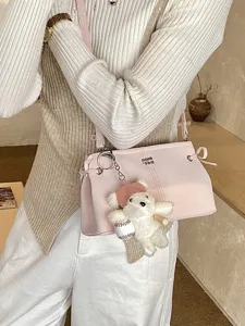 Korean style pink shoulder bag with cute bear plush pendant, trendy casual crossbody bag.