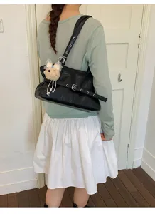 Black faux leather shoulder underarm bag for women, stylish commuting tote with cute bear pendant.
