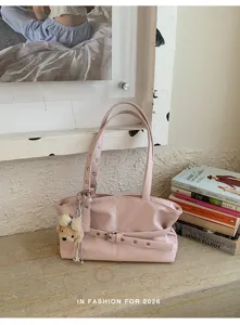 Casual large capacity pink shoulder bag with metal grommets, belt detail and cute charm.