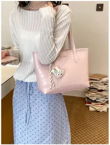 Stylish pink commuter shoulder tote bag with cute plush rabbit charm for daily office and school use.