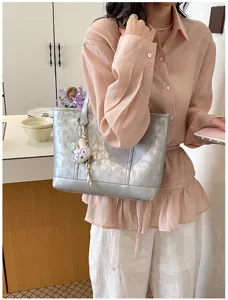 Stylish silver metallic tote bag for women, large capacity commuter shoulder bag for daily use.