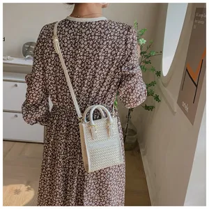 Detailed shot of a chic woven mini crossbody bag for women, stylish phone pouch, white color.