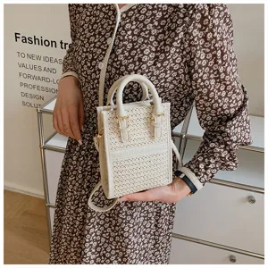 Small woven crossbody bag for women, summer vertical tote bag with top handle and strap.