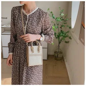 Stylish woven crossbody bag for women with chic top handle and stylish floral dress detail