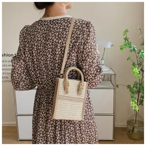 Summer woven crossbody bag for women, stylish small handbag with top handle and double buckle.