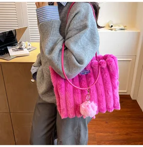 Pink fluffy plush tote bag for women, cute shoulder handbag with cute pompom charm details.