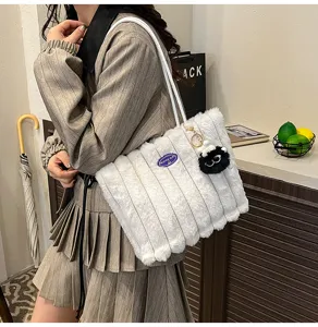 Fluffy white tote bag detail view, soft plush shoulder bag with cute keychain for daily commute.
