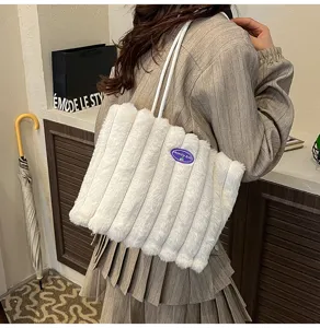 Fluffy shoulder tote bag detail view, soft white plush material for winter commuter style.