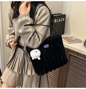 Fluffy black plush tote bag for women, cozy winter shoulder bag with cute pompom charm.