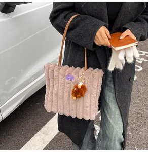 Fluffy plush tote bag detail view, soft shoulder bag with cute charm and comfortable handle.