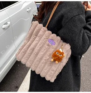 Fluffy plush tote bag for women, large capacity shoulder bag with cute monster pendant detail.