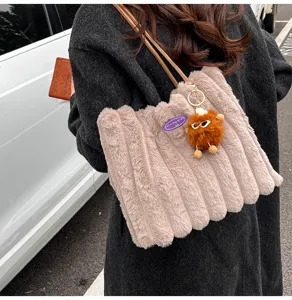 Plush shoulder tote bag for women, large capacity fluffy handbag with cute furry pendant.