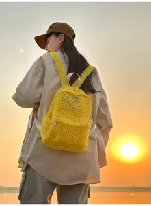 Stylish yellow mesh backpack for women, lightweight breathable travel beach daypack detail.