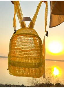 Yellow mesh backpack detail, lightweight breathable beach bag for summer travel and outdoor use.