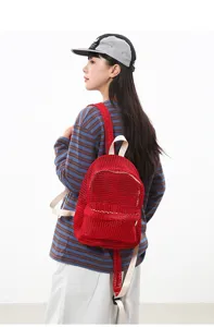 Details of the red mesh backpack, highlighting breathable mesh fabric and lightweight casual design.