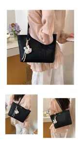 Minimalist large capacity black tote bag, stylish shoulder bag with cute rabbit pendant.